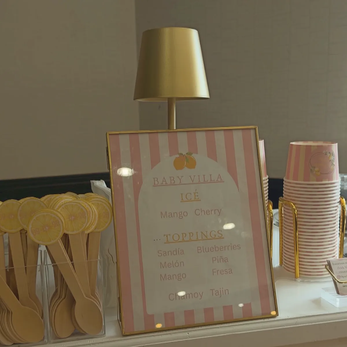 Custom menu, cups and gold details on a Mi Pueblito Dulce baby shower cart